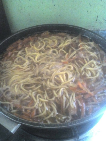 adding noodles to pan