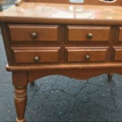Value and Information on a Mersman Table - medium wood table with faux six draw fronted drawer, turned legs and a backstop detail