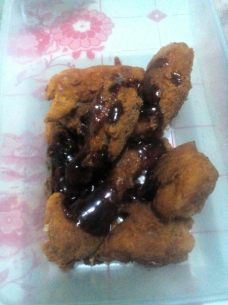 pouring sauce on Wings