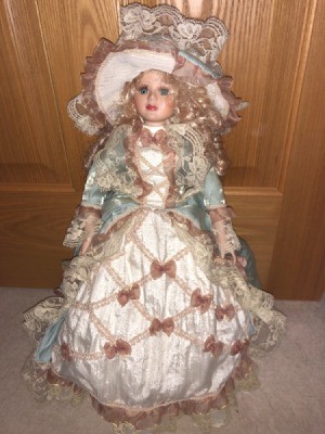 Identifying a Porcelain Doll- doll wearing an elaborate pink dress with jacket