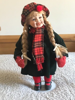 Identifying a Porcelain Doll - doll wearing a plaid hat and scarf