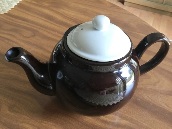 A classic round brown betty teapot with a white lid.