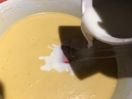 adding milk to batter