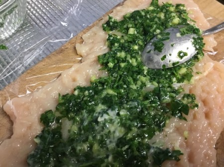 adding parsley butter to chicken