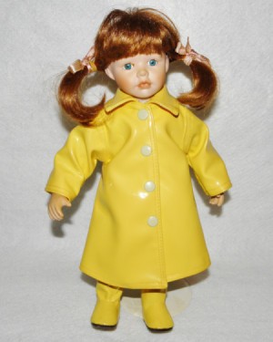 Value of a Cracker Barrel Porcelain Doll - red haired doll wearing a yellow rain coat and boots