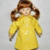 Value of a Cracker Barrel Porcelain Doll - red haired doll wearing a yellow rain coat and boots