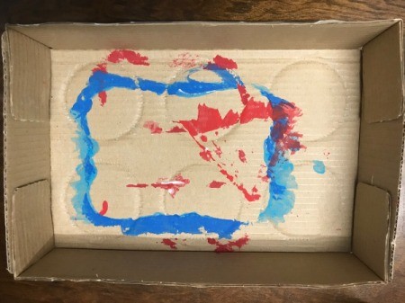 Mess Free Painting Using Cardboard Boxes - inside of cardboard box with evidence of blue and red paint