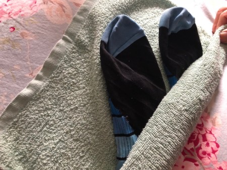 A pair of wet socks inside a towel.