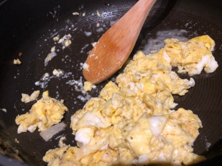 mixing cooking fried egg
