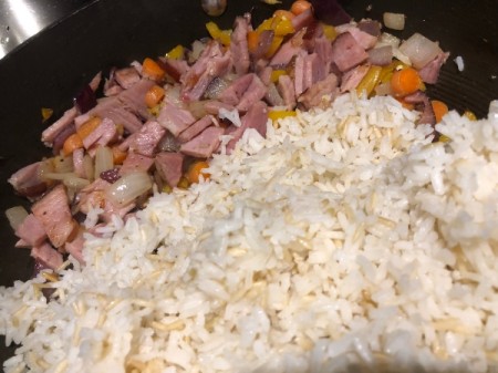 adding rice to ham and veggies