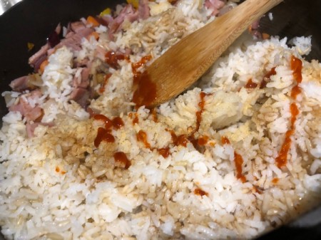 adding sauce to rice
