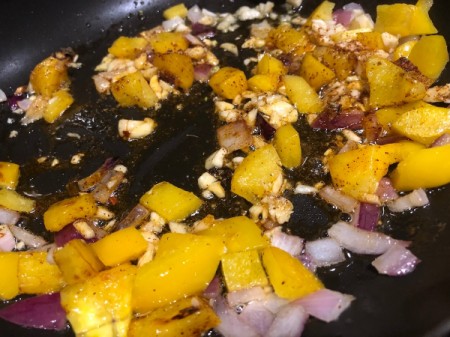 adding garlic and spices to pan