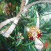 Use Costume Jewelry as Mini Ornaments - closeup of an angel pin ornament