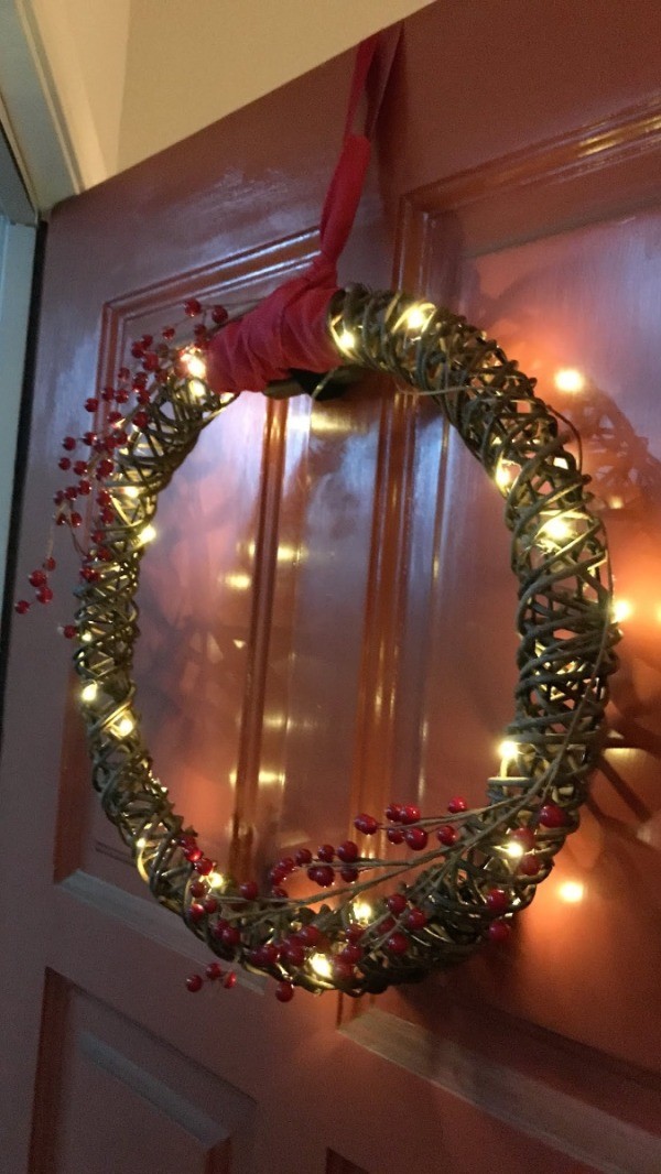 A wreath hanging from a ribbon.