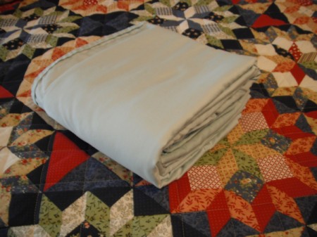 Folding Fitted Sheets - place hand in center and make final fold