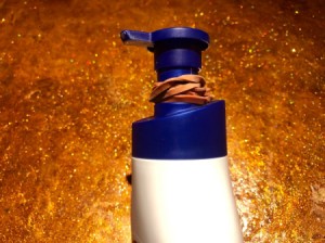 A rubber band on a lotion bottle to prevent the dispenser from going down fully.