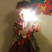 Identifying a Porcelain Doll - doll in long red dress holding a candle