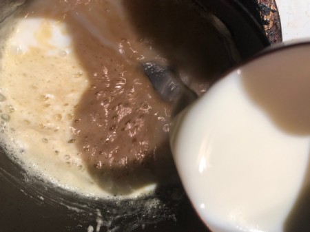adding milk to flour and butter