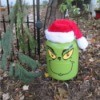 Helium Tank Upcycled as The Grinch - Grinch sitting on the ground outside