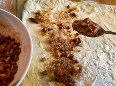spreading sugar mixture on dough