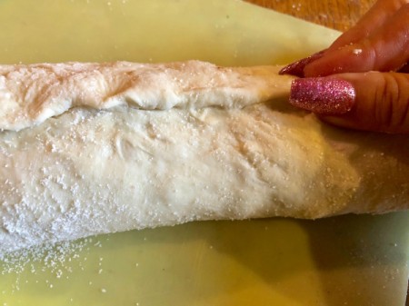 pinching Cinnamon Roll dough closed