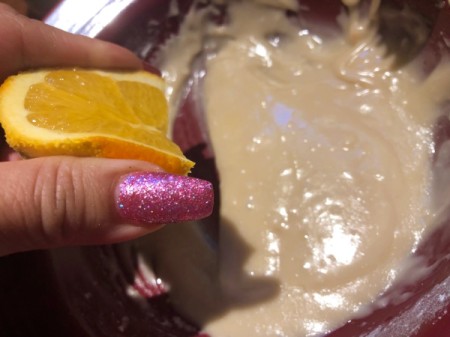 squeezing Orange juice into frosting
