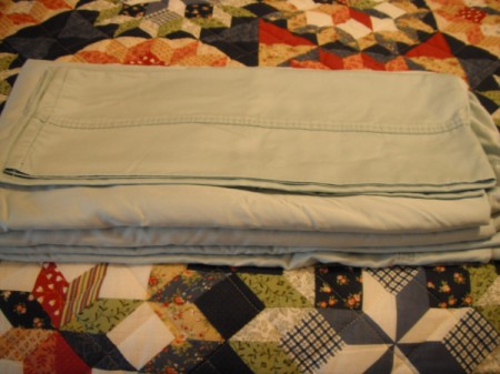 Folding Fitted Sheets - lay the fitted sheet on the top of the flat sheet, place pillow cases on top
