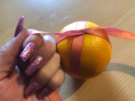 How to Make Orange Clove Pomanders - wrap the other way around like a present and tie another knot tightly on the other side