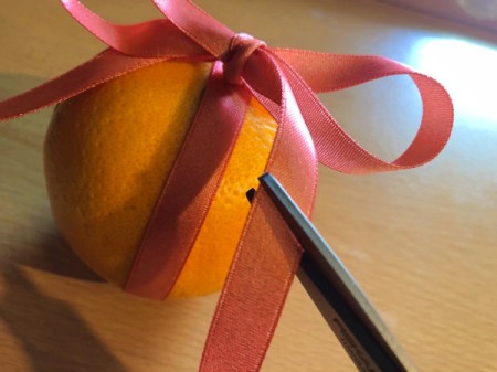 How to Make Orange Clove Pomanders - tie a bow and trim ends