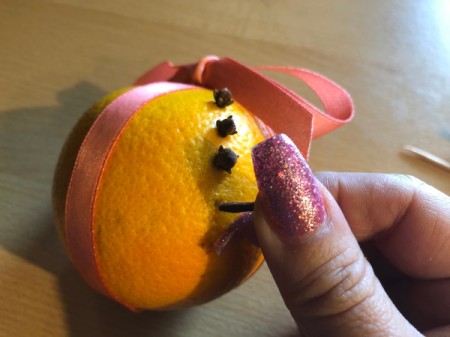 How to Make Orange Clove Pomanders - push the cloves into the holes