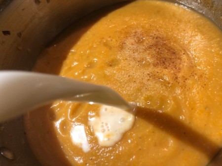 adding milk to soup