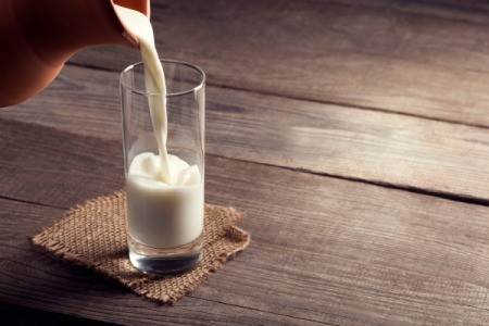 Pouring a glass of milk.