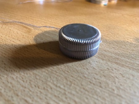 Plastic Bottle Cap Ornaments - add a line of glue around the lip of the cap and glue another one one