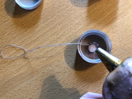 Plastic Bottle Cap Ornaments - glue the knotted end down inside the cap