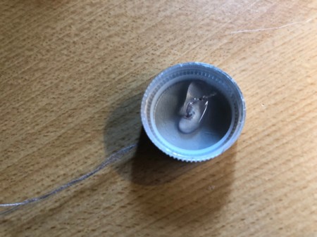 Plastic Bottle Cap Ornaments - add a blob of glue to close the hole and secure the hanger