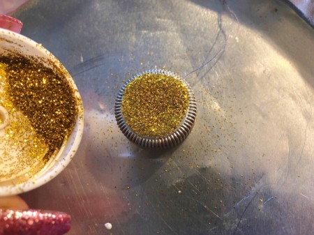 Plastic Bottle Cap Ornaments - add glitter and shake off excess