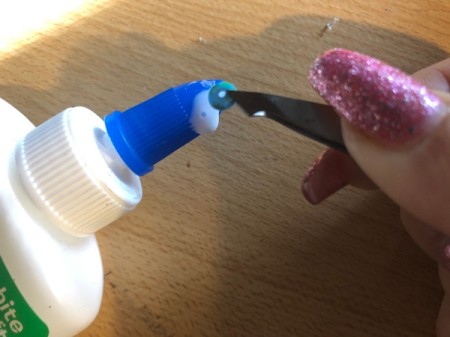 Plastic Bottle Cap Ornaments - use tweezers to add a bit of glue to the back of sequins