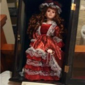Value of an Ashley Belle Doll - doll wearing a red dress trimmed in white lace