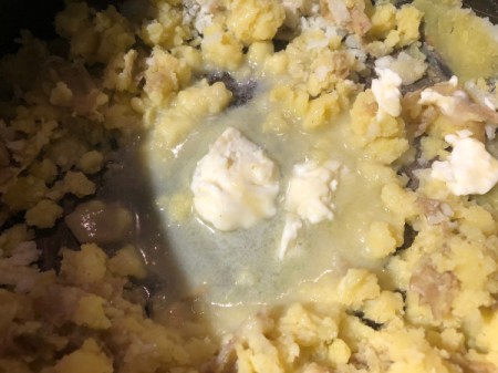 adding garlic, butter and cheese to Mashed Potatoes
