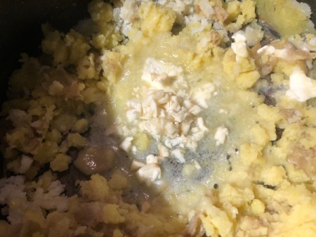adding garlic, butter and cheese to Mashed Potatoes