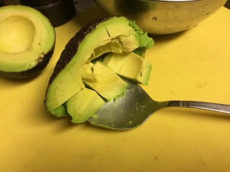 spooning out scored Avocado