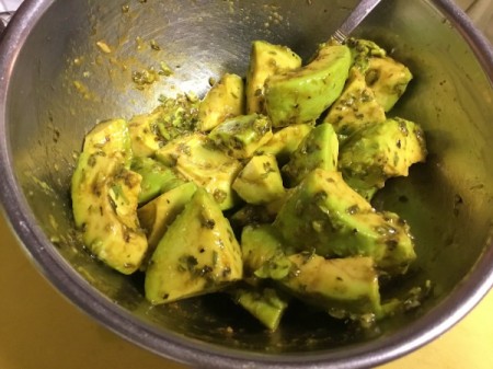 Avocado, oil and herbs in bowl