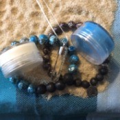 Name Ideas for a Handmade Jewelry and Body Products Business - bracelets and small jars on a bed of sand