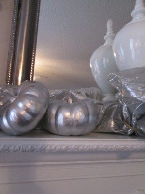 Transforming Gourds Into Elegant Decor - two gourds on a white mantle
