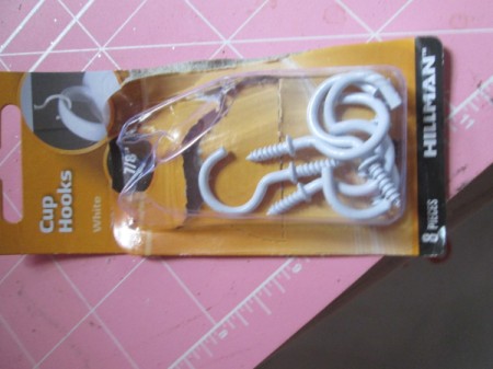 Cup hooks for hanging chains for wrapping paper.