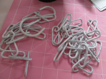 Chains for holding rods for wrapping paper.