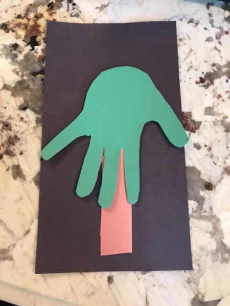 Christmas Tree Card Made by a Toddler - glue one of the hand cutouts overlapping the trunk with the fingers pointing down