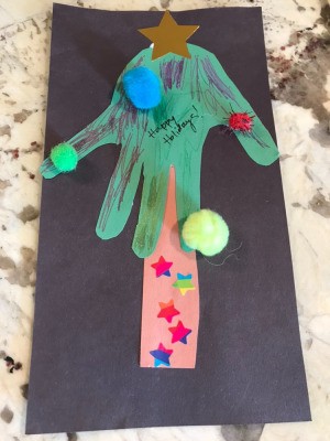 Christmas Tree Card Made by a Toddler - finished card with pom poms added to the tips of fingers and on the palm of the hand