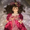 Value of a Collector's Choice Porcelain Doll - doll in satin dress with lace trim