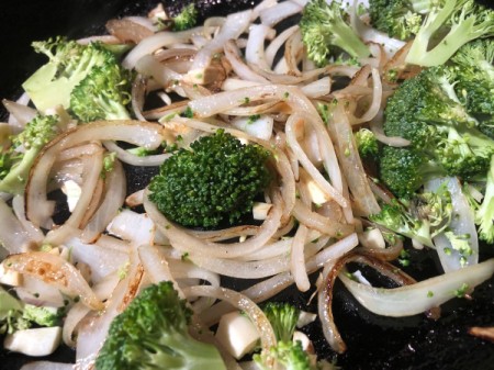 adding broccoli to onions